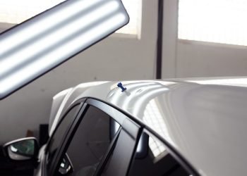 Hail-damage dents across a car roof